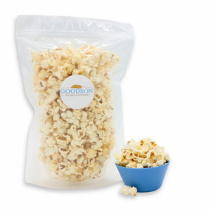 6oz bag of popcorn with a Goodson label next to a small blue bowl filled with popcorn on a white background