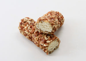 Two log-shaped pecan rolls against a white background.
