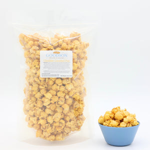 14oz bag of Goodson popcorn with a small bowl of popcorn on a white background