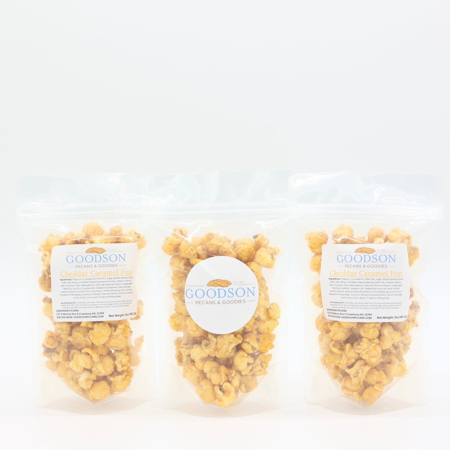 Three 2oz bags of Goodson popcorn on a white background