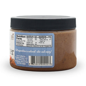 Jar of pecan butter with a label showing nutrition facts and other details on a white background