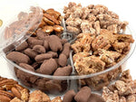 Assorted shelled pecans including chocolate-covered and roasted in a clear container.