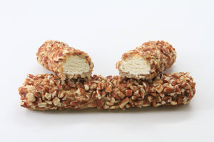 Two pecan rolls, one split in half, showing nougat filling, on top of the second