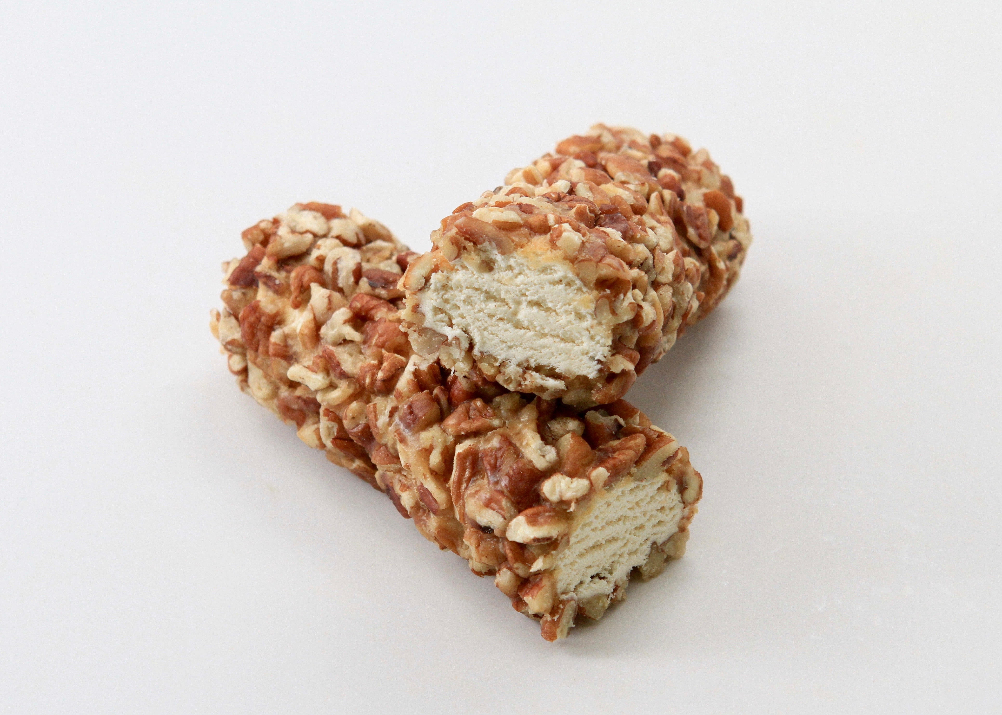 Two log-shaped pecan rolls against a white background.