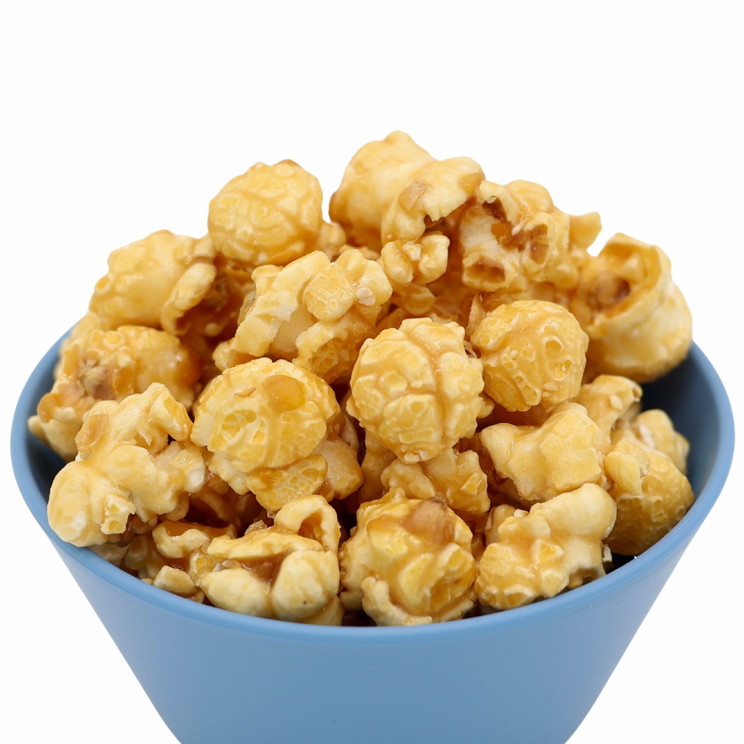 Blue bowl filled with caramel coated popcorn against a white background.