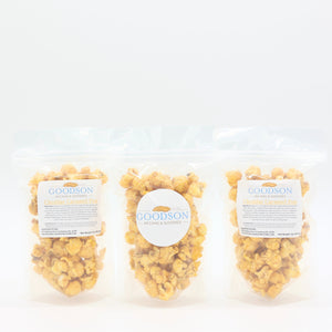 Three 2oz bags of Goodson popcorn on a white background