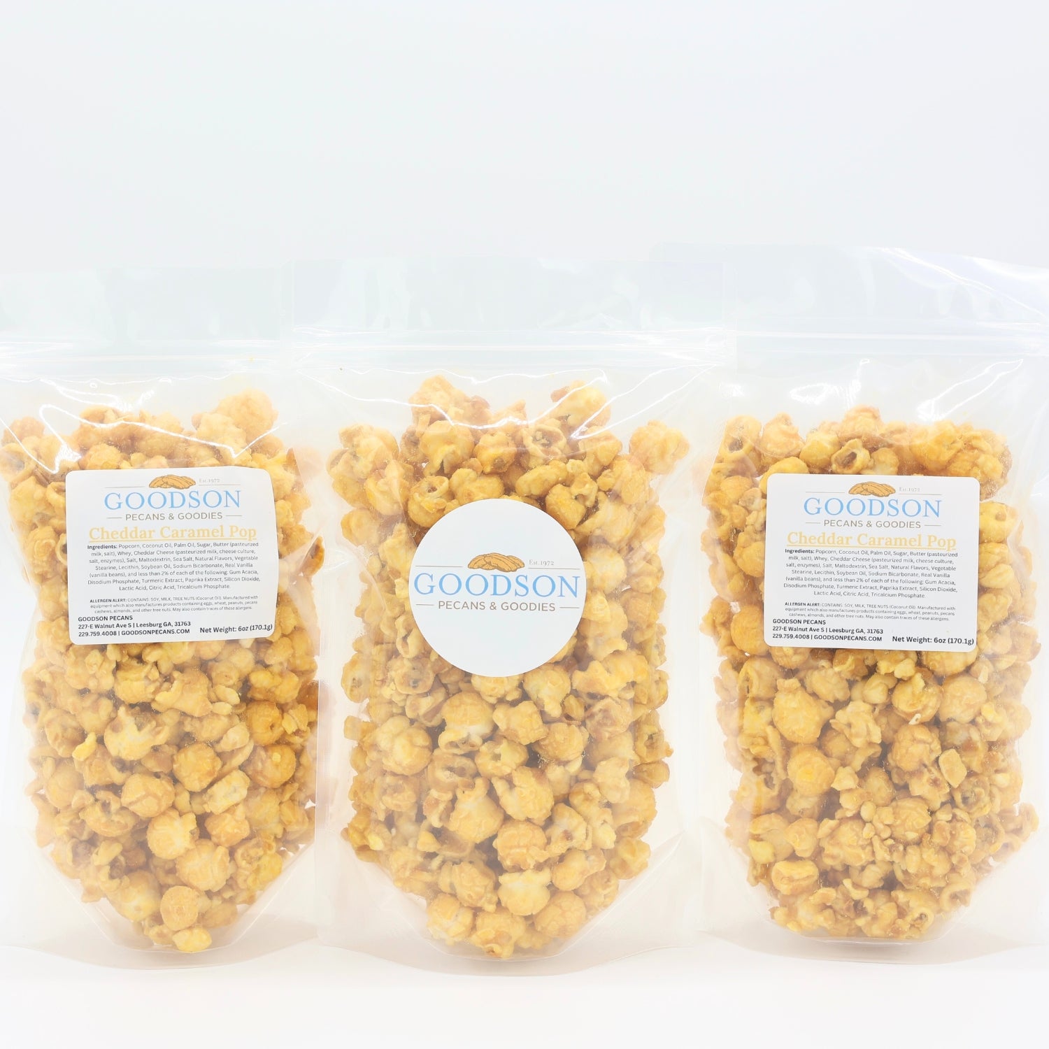 Three bags of Goodson popcorn on a white background