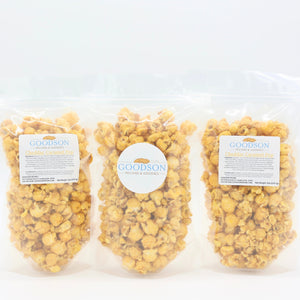 Three bags of Goodson popcorn on a white background