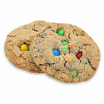 Two Crunchy Munchy cookies with chocolate candy pieces against a white background.