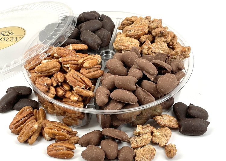 Assorted nuts including pecans and chocolate-coated pecans in a clear container on a white background.